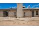 A home's backyard featuring a light brick exterior and concrete patio at 1225 E Jacob Ln, Phoenix, AZ 85020