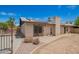 A home's backyard featuring a light brick exterior, solar panels, and a patio at 1225 E Jacob Ln, Phoenix, AZ 85020