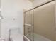 Bathroom featuring toilet and a shower with glass sliding doors at 1225 E Jacob Ln, Phoenix, AZ 85020