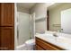 Bathroom featuring a sink, toilet, and glass door shower at 1225 E Jacob Ln, Phoenix, AZ 85020