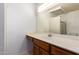 Bathroom with solid-surface countertops, wood cabinets, and a large mirror at 1225 E Jacob Ln, Phoenix, AZ 85020