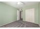 Cozy bedroom with a ceiling fan, double door closet, and light green walls at 1225 E Jacob Ln, Phoenix, AZ 85020