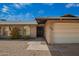 Charming single-story brick home with a two car garage and gravel landscaping at 1225 E Jacob Ln, Phoenix, AZ 85020