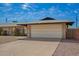 Charming single-story brick home with a two car garage and gravel landscaping at 1225 E Jacob Ln, Phoenix, AZ 85020