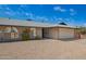 Charming single-story brick home with a two car garage and gravel landscaping at 1225 E Jacob Ln, Phoenix, AZ 85020