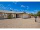 Charming single-story brick home with a two car garage and gravel landscaping at 1225 E Jacob Ln, Phoenix, AZ 85020