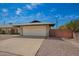 Charming single-story brick home with a two car garage and gravel landscaping at 1225 E Jacob Ln, Phoenix, AZ 85020