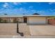 Charming single-story brick home with a two car garage and gravel landscaping at 1225 E Jacob Ln, Phoenix, AZ 85020