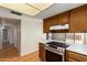 Open kitchen featuring wood cabinets, a stainless steel oven, and white countertops at 1225 E Jacob Ln, Phoenix, AZ 85020