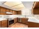 Well-lit kitchen with modern appliances, light countertops, and wood cabinets at 1225 E Jacob Ln, Phoenix, AZ 85020