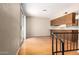 Open living room features hardwood floors, access to a large sliding door, and a passthrough to the kitchen at 1225 E Jacob Ln, Phoenix, AZ 85020