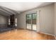 Living room featuring hardwood floors, brick fireplace, and sliding door leading to a fenced backyard at 1225 E Jacob Ln, Phoenix, AZ 85020
