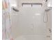 Clean bathroom area with a shower, white tile surround, and essential fixtures for a functional space at 12913 W Columbine Dr, El Mirage, AZ 85335