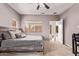 Cozy bedroom featuring neutral walls, carpet, and a ceiling fan, offering a relaxing retreat at 12913 W Columbine Dr, El Mirage, AZ 85335