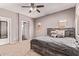 Bedroom features a large bed, neutral color palette, carpet flooring, and a ceiling fan for added comfort at 12913 W Columbine Dr, El Mirage, AZ 85335