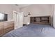 Bedroom with neutral walls and built-in shelves providing storage and style at 12913 W Columbine Dr, El Mirage, AZ 85335