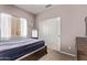 Clean bedroom featuring a window and a closet with sliding doors at 12913 W Columbine Dr, El Mirage, AZ 85335