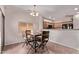 Dining area featuring an wood table with seating for four and sliding glass doors at 12913 W Columbine Dr, El Mirage, AZ 85335