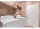 Laundry room featuring appliances and extra storage at 12913 W Columbine Dr, El Mirage, AZ 85335