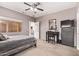 Comfortable main bedroom features a ceiling fan, dresser, vanity, and carpeted floors at 12913 W Columbine Dr, El Mirage, AZ 85335