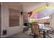 Covered patio area with outdoor table and chairs, offering a relaxing space to enjoy the outdoors at 12913 W Columbine Dr, El Mirage, AZ 85335