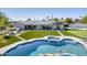 Aerial view showcasing the backyard with a pool, fire pit, sport court, and expansive artificial turf at 13365 N 74Th St, Scottsdale, AZ 85260