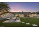 Picturesque backyard featuring a modern fire pit, outdoor seating, a grill, and a lush lawn at 13365 N 74Th St, Scottsdale, AZ 85260