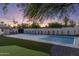 Large backyard featuring a pickle ball court, artificial lawn, mature trees and a privacy wall at 13365 N 74Th St, Scottsdale, AZ 85260