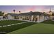 Expansive backyard with manicured lawn, an outdoor dining area, and cozy seating, perfect for entertaining at 13365 N 74Th St, Scottsdale, AZ 85260