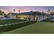 Spacious backyard with artificial turf, an outdoor kitchen, covered patio, and stepped pavers at 13365 N 74Th St, Scottsdale, AZ 85260