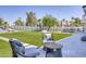 Expansive backyard featuring lush green lawn, pool with water slide, and outdoor seating area at 13365 N 74Th St, Scottsdale, AZ 85260