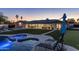 Beautiful backyard with a pool, spa, fire pit, and outdoor kitchen, ideal for luxurious outdoor living at 13365 N 74Th St, Scottsdale, AZ 85260