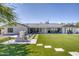 Expansive backyard featuring artificial turf, a built-in grill, and a charming fire pit with ample seating at 13365 N 74Th St, Scottsdale, AZ 85260
