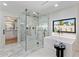 A spa-like bathroom with a glass shower, soaking tub, and a view to the outdoors at 13365 N 74Th St, Scottsdale, AZ 85260