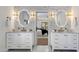 Bright bathroom features dual vanity sinks, illuminated mirrors, and marble hexagon tile accent wall at 13365 N 74Th St, Scottsdale, AZ 85260
