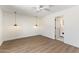 Bright bedroom with wood-look flooring and contemporary light fixtures, leading to an ensuite bathroom at 13365 N 74Th St, Scottsdale, AZ 85260