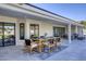 Covered patio dining area with a stylish wooden table and chairs, ideal for outdoor meals and gatherings at 13365 N 74Th St, Scottsdale, AZ 85260