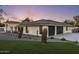 Stunning exterior featuring a modern design, desert landscaping, and a spacious three-car garage at 13365 N 74Th St, Scottsdale, AZ 85260