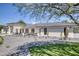 Beautiful exterior featuring sleek black window trim, desert landscaping, and a well-manicured yard at 13365 N 74Th St, Scottsdale, AZ 85260
