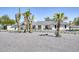 Gorgeous white single-story house featuring black trim, a well-kept yard, and desert landscaping at 13365 N 74Th St, Scottsdale, AZ 85260