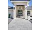 Elegant front entrance featuring black double doors, modern lighting fixtures, and stone walkway at 13365 N 74Th St, Scottsdale, AZ 85260