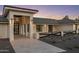 Striking front entrance with grand columns, contemporary lighting, and a paved walkway, enhancing curb appeal at 13365 N 74Th St, Scottsdale, AZ 85260