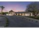A single-story home featuring desert landscaping, a circular driveway and a white exterior and black trim at 13365 N 74Th St, Scottsdale, AZ 85260