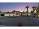 Striking single-story home featuring desert landscaping, a circular driveway and a white exterior at 13365 N 74Th St, Scottsdale, AZ 85260