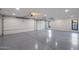 Spacious three-car garage with epoxy flooring, ample lighting, and modern garage door openers at 13365 N 74Th St, Scottsdale, AZ 85260