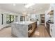 Bright kitchen features an island with marble countertop, seating, and stainless steel appliances at 13365 N 74Th St, Scottsdale, AZ 85260