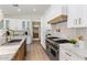 Close up of the stainless steel range, stone countertop, and white tiled backsplash at 13365 N 74Th St, Scottsdale, AZ 85260