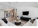 Bright living room with a dark accent wall, fireplace, and tiled floors at 13365 N 74Th St, Scottsdale, AZ 85260
