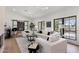 Bright living room with a large sectional couch, tiled floors, and backyard views at 13365 N 74Th St, Scottsdale, AZ 85260