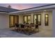 Charming outdoor dining area with seating for six, complemented by modern black-framed windows and doors at 13365 N 74Th St, Scottsdale, AZ 85260
